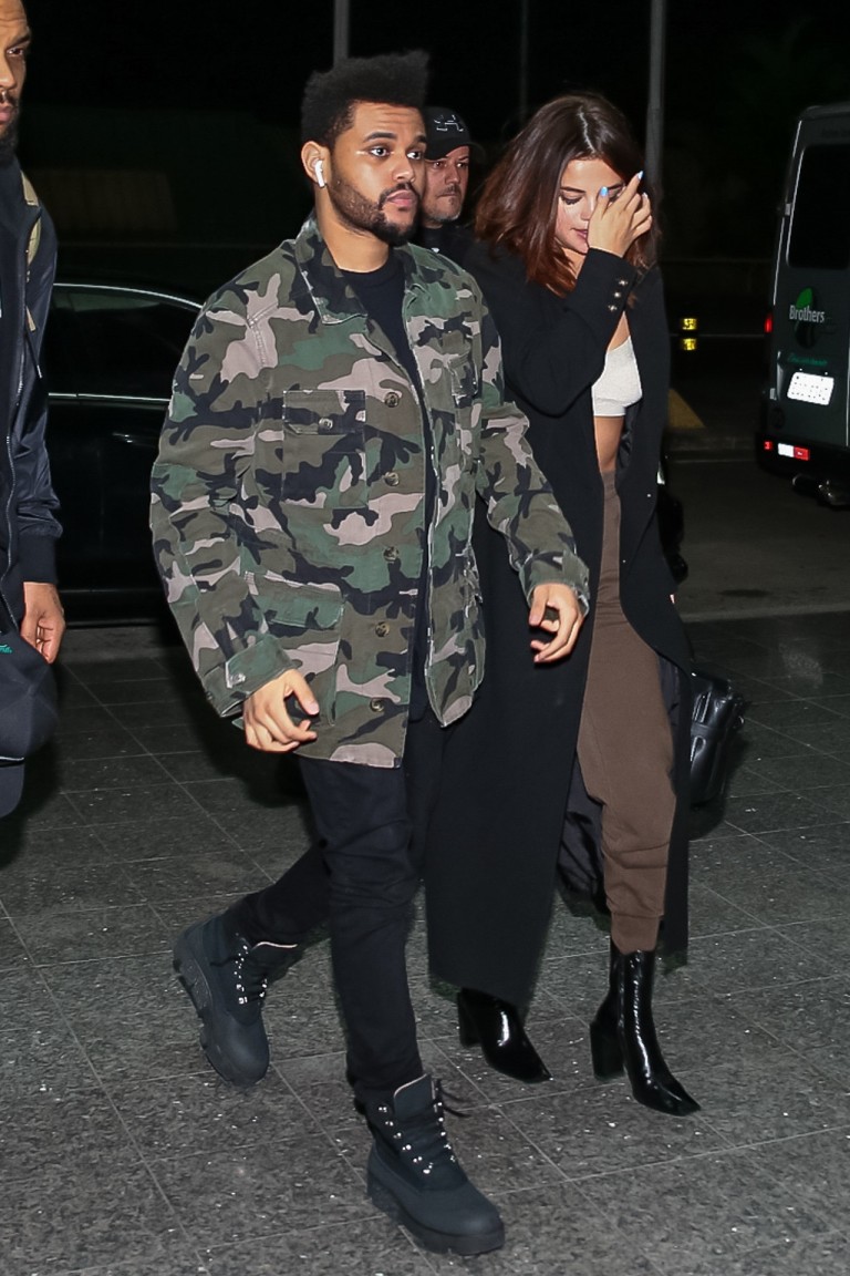 *EXCLUSIVE* The Weeknd and Selena Gomez keep close on their way to a flight after Lollapalooza Brazil